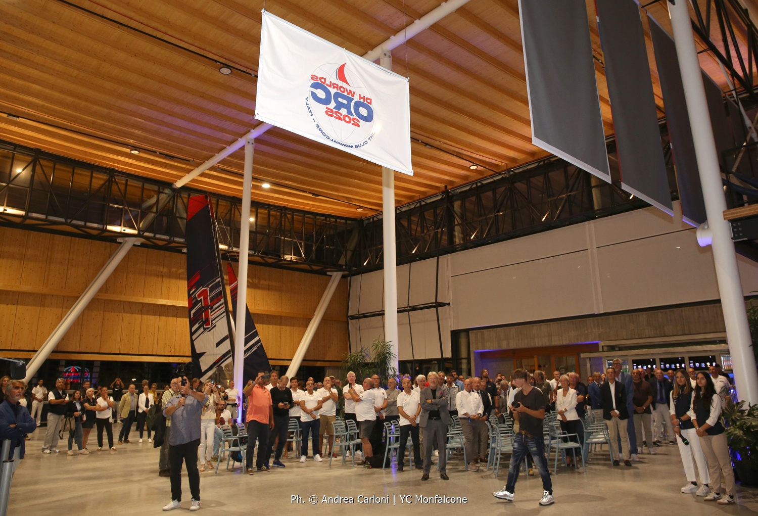 Hoisting the event flag - Opening Ceremony in Olympic Hangar