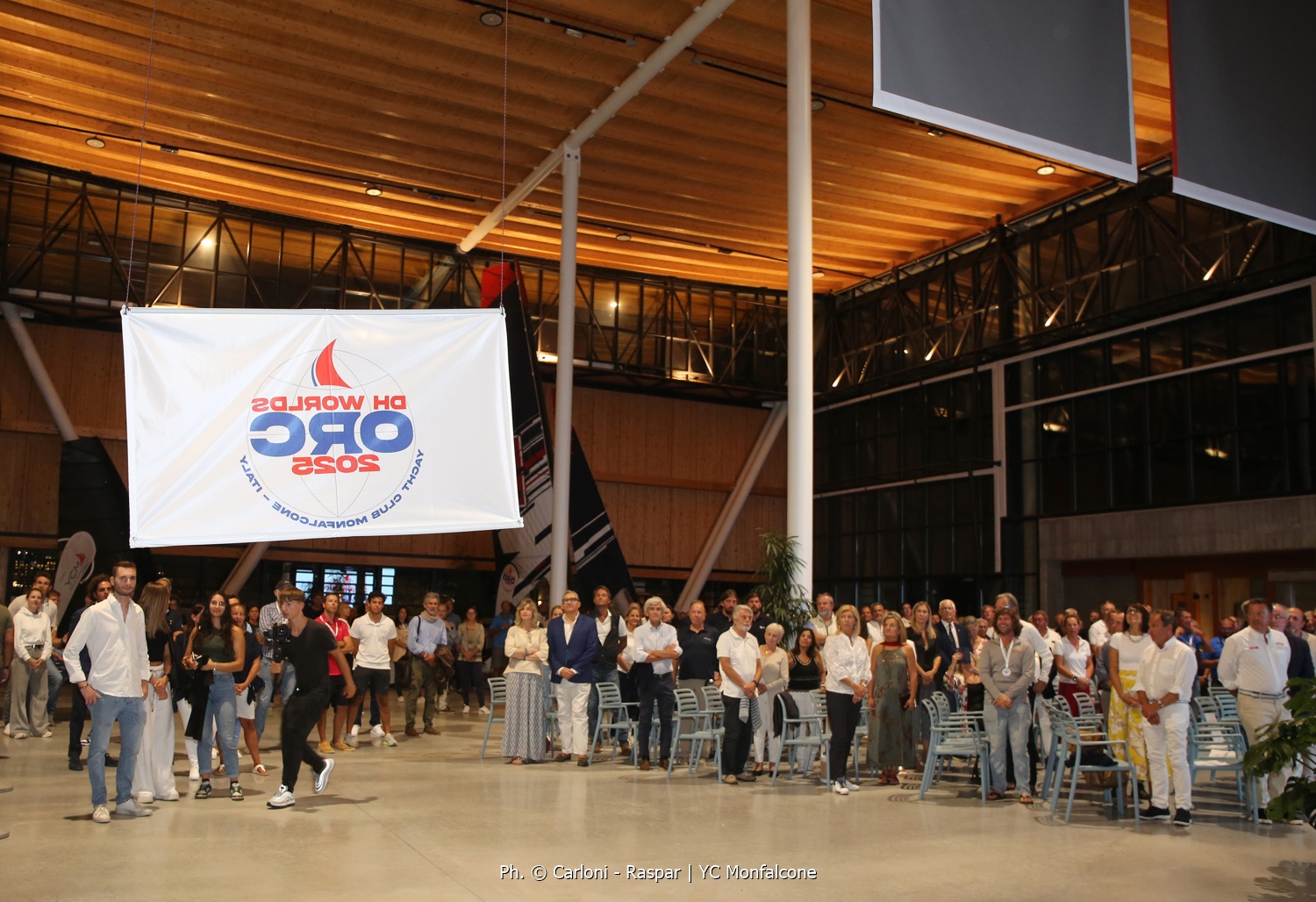 Lowering the event flag in Olympic Hangar in Marina Monfalcone - ORC DH Worlds 2025 © YCM | Carloni - Raspar