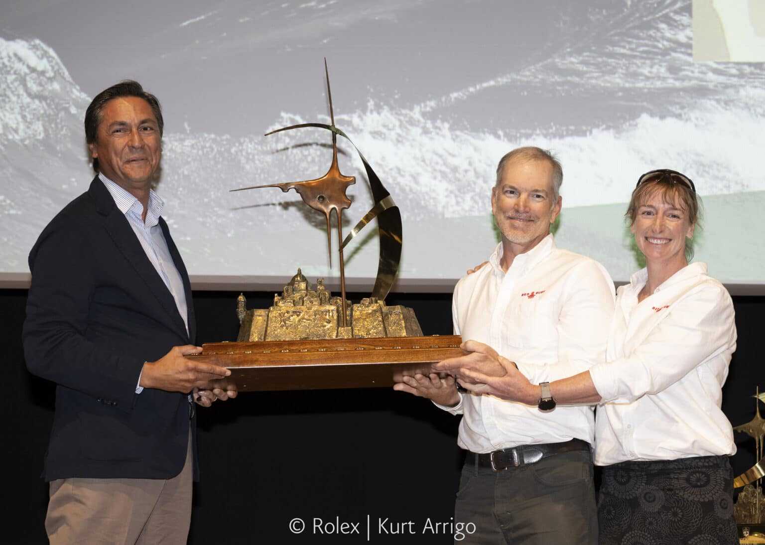 Andrea Recordati, Bullitt, shares a moment with the Rolex Middle Sea Race Trophy with Justin and Christina Wolfe, Red Ruby © Kurt Arrigo