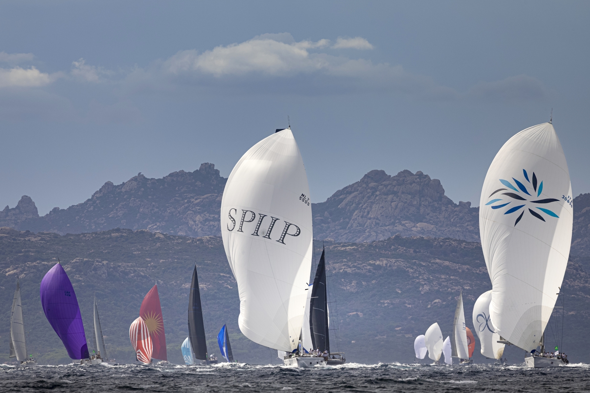 The Swan Maxi yachts powered by the mistral in the Gulf of Arzachena, Rolex Swan Cup 2026. Photo credit: Rolex/Studio Borlenghi